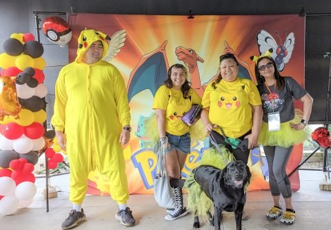 A group of trainers in a Pikachu costume